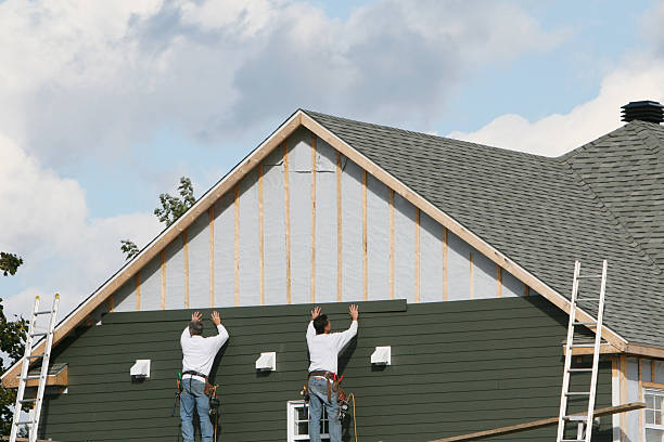 Professional Storm Damage Siding Repair technician working in Oakland Mills, PA
